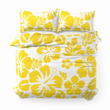 A top-down view of a king bedding set featuring a white duvet cover and two matching pillowcases with a bold yellow hibiscus floral pattern, set against a plain white background.